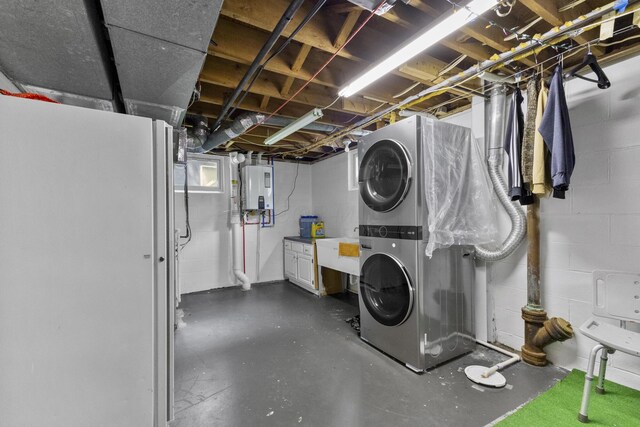 5280 Elmhurst Ave, Columbus, OH 43231 - unfinished basement featuring stacked washing machine and dryer, water heater, concrete block wall, and a sink