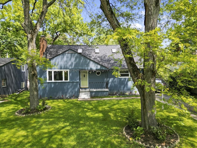 5280 Elmhurst Ave, Columbus, OH 43231 - view of front facade featuring a shingled roof, a front yard, and a chimney