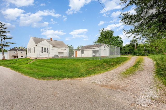 12 E Vine St, Jackson, OH 45640 - view of property exterior featuring a chimney, dirt driveway, and central AC unit