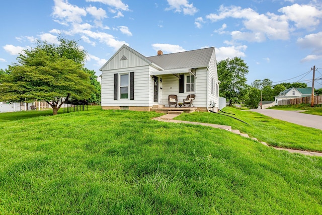 12 E Vine St, Jackson, OH 45640 - view of front of property featuring covered porch, a chimney, metal roof, and board and batten siding