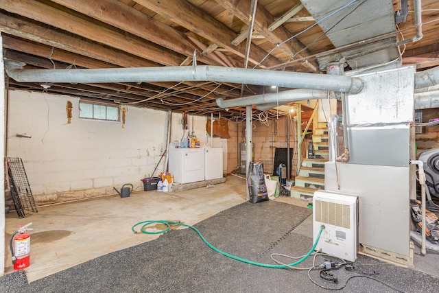 12 E Vine St, Jackson, OH 45640 - unfinished below grade area featuring water heater, washer and clothes dryer, and stairway