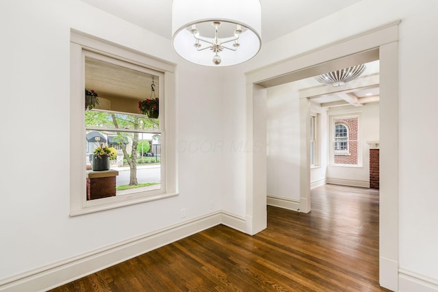 37 W 2nd Ave, Columbus, OH 43201 - empty room with dark wood-style floors, a chandelier, and baseboards