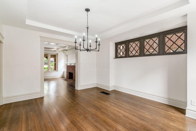 37 W 2nd Ave, Columbus, OH 43201 - unfurnished dining area with wood finished floors, a chandelier, baseboards, and a tray ceiling