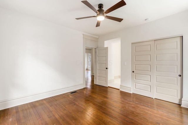 37 W 2nd Ave, Columbus, OH 43201 - unfurnished bedroom with a closet, wood-type flooring, ceiling fan, and baseboards