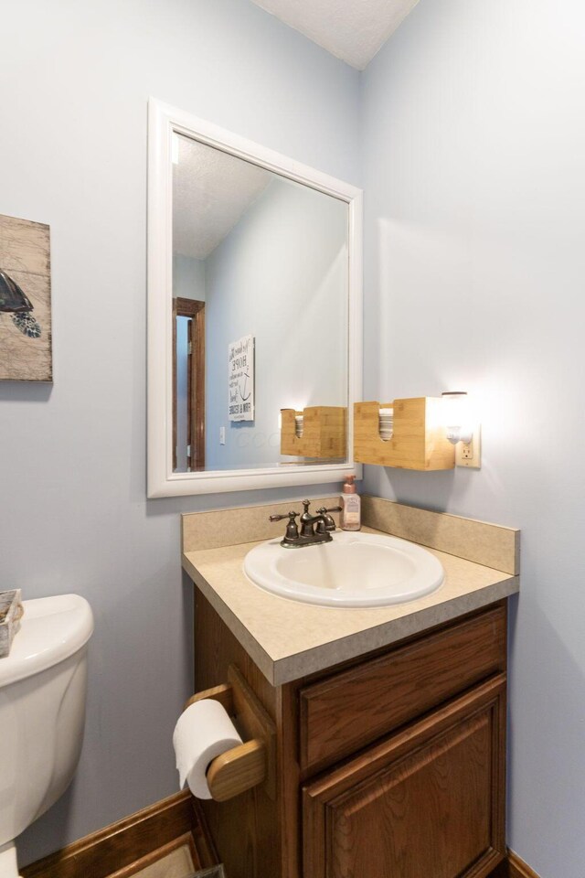 5103 Johnstown Alexandria Rd, Johnstown, OH 43031 - half bath featuring vanity, toilet, and baseboards