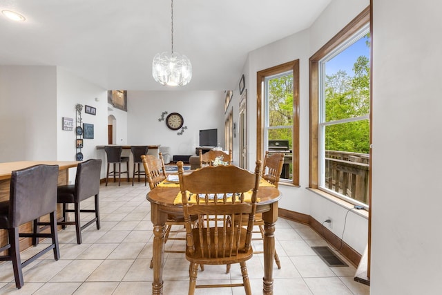 5103 Johnstown Alexandria Rd, Johnstown, OH 43031 - dining space featuring light tile patterned floors, arched walkways, a chandelier, and baseboards