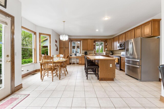 5103 Johnstown Alexandria Rd, Johnstown, OH 43031 - kitchen with appliances with stainless steel finishes, brown cabinets, light countertops, decorative backsplash, and recessed lighting