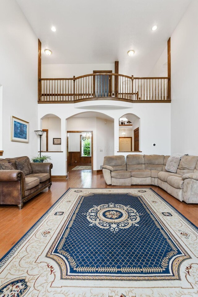 5103 Johnstown Alexandria Rd, Johnstown, OH 43031 - living area with arched walkways, a towering ceiling, wood finished floors, and recessed lighting