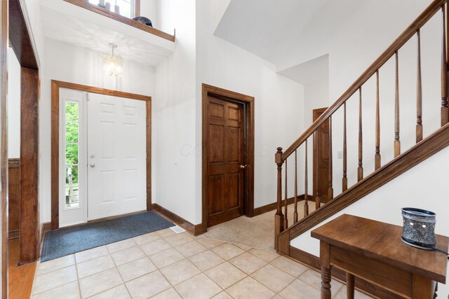 5103 Johnstown Alexandria Rd, Johnstown, OH 43031 - entrance foyer with light colored carpet, baseboards, a chandelier, and stairs