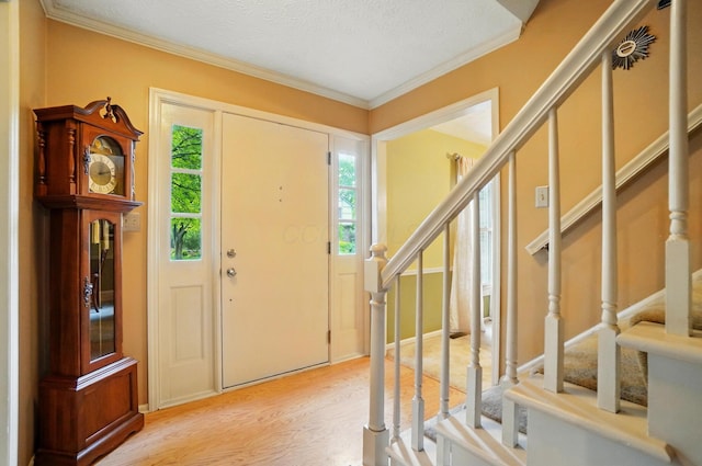 2517 Slateshire Dr, Dublin, OH 43016 - foyer with stairway, wood finished floors, ornamental molding, and a textured ceiling