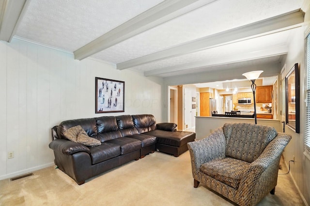 2517 Slateshire Dr, Dublin, OH 43016 - living area featuring beam ceiling, light carpet, and baseboards