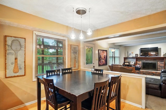 2517 Slateshire Dr, Dublin, OH 43016 - dining area with plenty of natural light, a fireplace, and baseboards