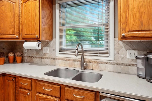 2517 Slateshire Dr, Dublin, OH 43016 - kitchen with a sink, light countertops, dishwashing machine, and decorative backsplash