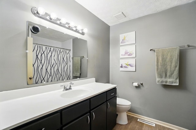 2517 Slateshire Dr, Dublin, OH 43016 - full bath with wood finished floors, vanity, toilet, a textured ceiling, and baseboards