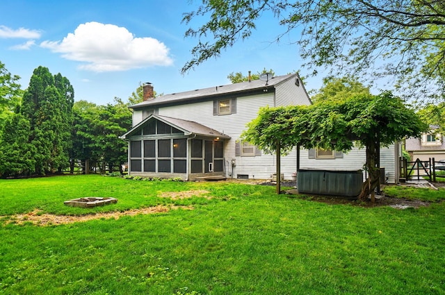 2517 Slateshire Dr, Dublin, OH 43016 - rear view of property featuring a hot tub, a sunroom, a yard, and a fire pit