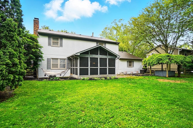 2517 Slateshire Dr, Dublin, OH 43016 - rear view of property featuring a chimney, a sunroom, a lawn, and central AC