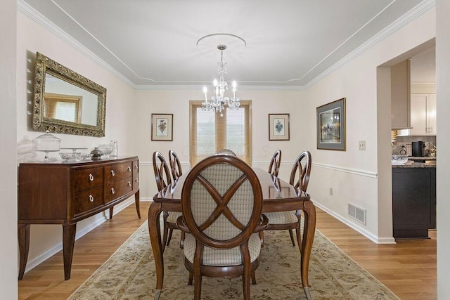 4606 Gershwin Ct, Grove City, OH 43123 - dining space featuring a chandelier, light wood-type flooring, ornamental molding, and baseboards