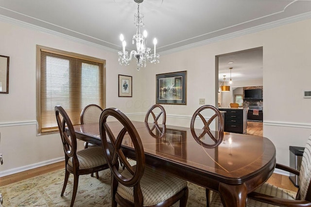 4606 Gershwin Ct, Grove City, OH 43123 - dining area with light wood finished floors, ornamental molding, baseboards, and a chandelier