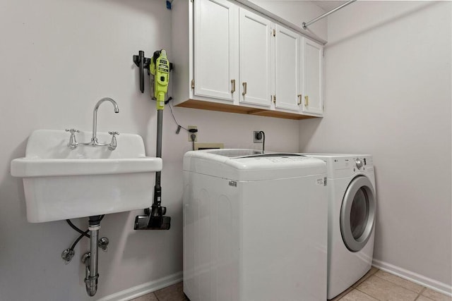 4606 Gershwin Ct, Grove City, OH 43123 - laundry area featuring cabinet space, independent washer and dryer, light tile patterned floors, and baseboards