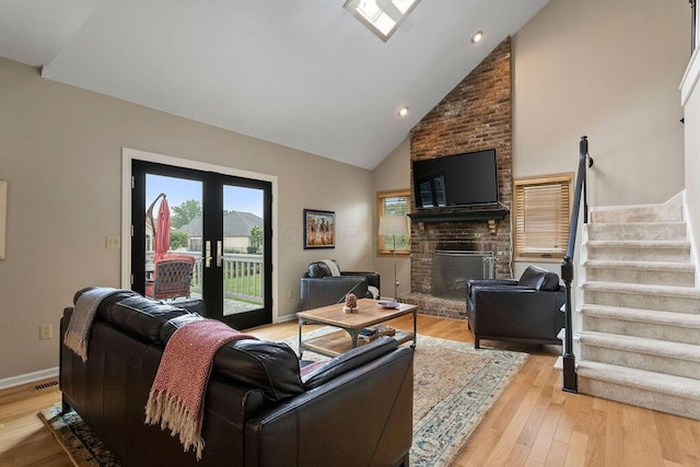4606 Gershwin Ct, Grove City, OH 43123 - living area featuring stairway, a fireplace, light wood finished floors, high vaulted ceiling, and recessed lighting