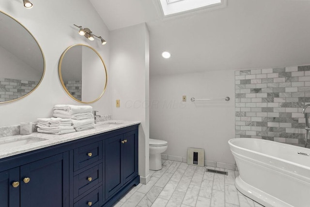 4606 Gershwin Ct, Grove City, OH 43123 - bathroom featuring double vanity, a freestanding bath, marble finish floors, a skylight, and vaulted ceiling