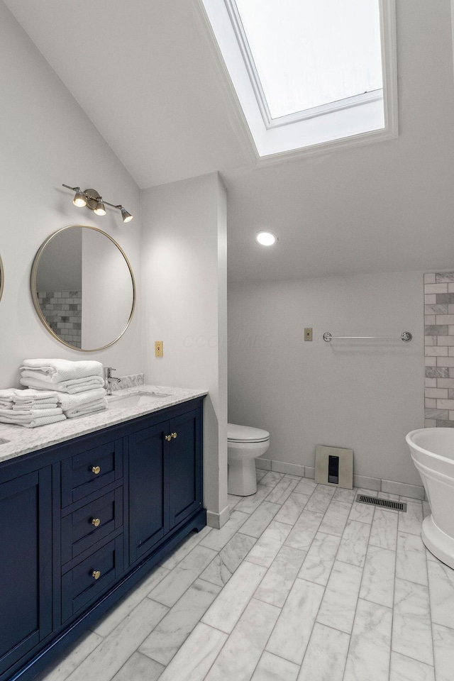 4606 Gershwin Ct, Grove City, OH 43123 - full bathroom with marble finish flooring, a skylight, vanity, toilet, and a freestanding tub