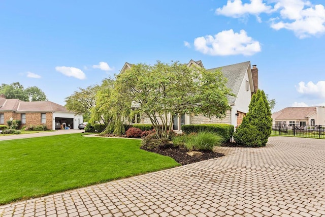 4606 Gershwin Ct, Grove City, OH 43123 - view of front of house with decorative driveway, a chimney, and an attached garage