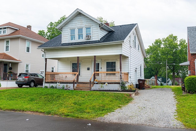 236 Ruth Ave, Mansfield, OH 44907 - bungalow-style home featuring covered porch, a front lawn, a shingled roof, a chimney, and cooling unit