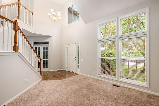 7985 Eric Ct, Lewis Center, OH 43035 - entrance foyer with carpet floors, a chandelier, baseboards, stairway, and high vaulted ceiling