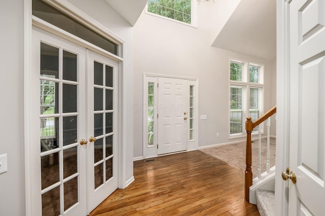 7985 Eric Ct, Lewis Center, OH 43035 - entrance foyer with french doors, stairs, wood-type flooring, baseboards, and a towering ceiling