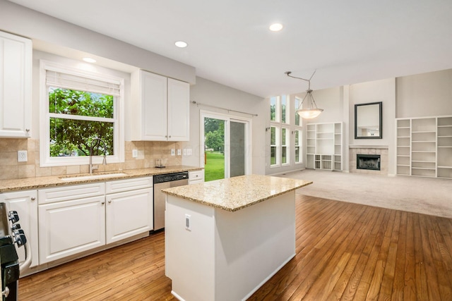 7985 Eric Ct, Lewis Center, OH 43035 - kitchen with dishwasher, a sink, range, white cabinets, and a kitchen island