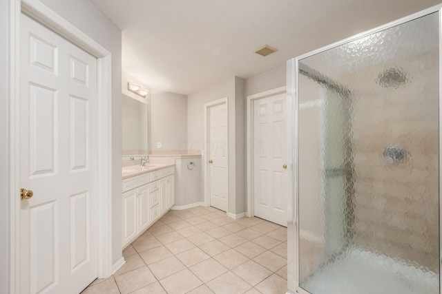 7985 Eric Ct, Lewis Center, OH 43035 - bathroom with tile patterned flooring, a shower stall, vanity, and baseboards