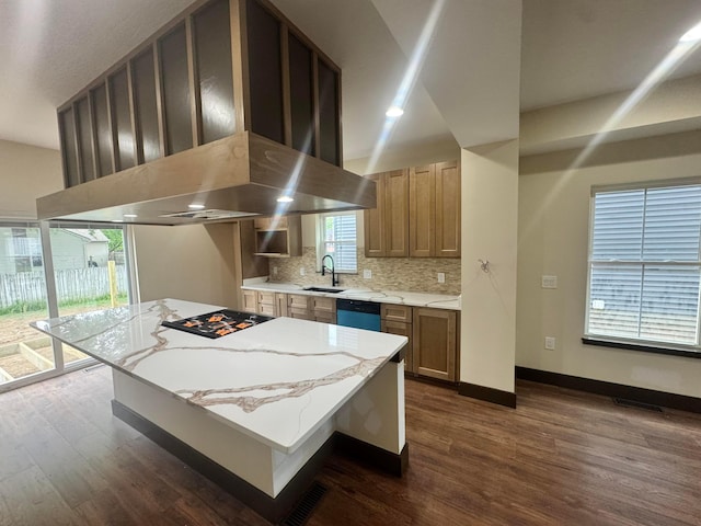 1624 Marlboro Ave, Obetz, OH 43207 - kitchen featuring wall chimney exhaust hood, dishwashing machine, dark wood-type flooring, tasteful backsplash, and cooktop