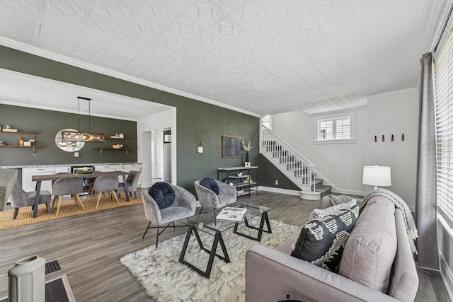 211 Guernsey Ave, Columbus, OH 43204 - living area featuring wood finished floors, stairway, a chandelier, baseboards, and an ornate ceiling