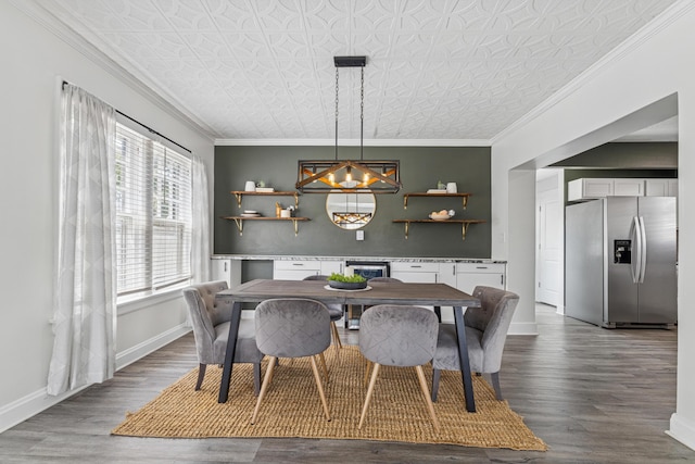 211 Guernsey Ave, Columbus, OH 43204 - dining room with an ornate ceiling, wood finished floors, crown molding, a chandelier, and baseboards