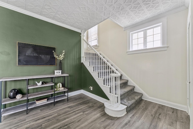 211 Guernsey Ave, Columbus, OH 43204 - stairway featuring an ornate ceiling, baseboards, wood finished floors, and ornamental molding
