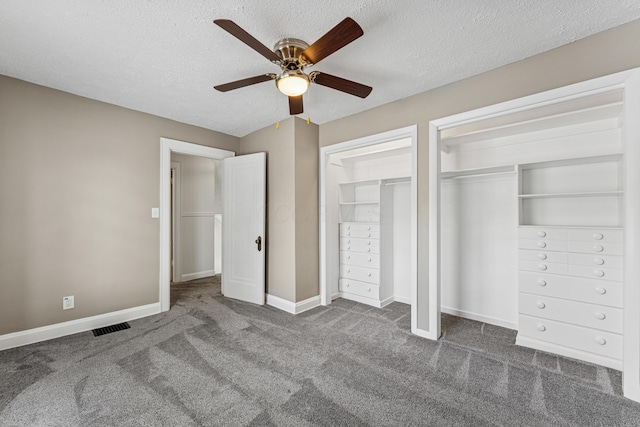 211 Guernsey Ave, Columbus, OH 43204 - unfurnished bedroom with multiple closets, carpet flooring, a textured ceiling, baseboards, and ceiling fan