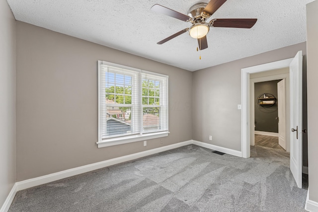 211 Guernsey Ave, Columbus, OH 43204 - carpeted empty room featuring a textured ceiling, baseboards, and a ceiling fan