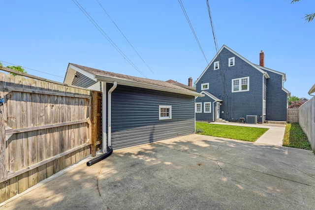 211 Guernsey Ave, Columbus, OH 43204 - rear view of house with central AC, a fenced backyard, a chimney, and a patio