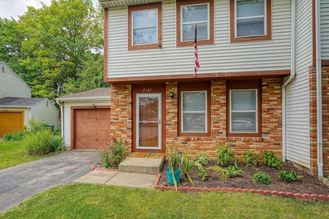 7581-7583 Pickett Ln Unit 83, Columbus, OH 43235 - view of front facade with asphalt driveway, a garage, and brick siding