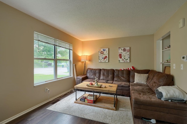 7581-7583 Pickett Ln Unit 83, Columbus, OH 43235 - living area with a textured ceiling, dark wood-style flooring, and baseboards