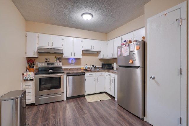 7581-7583 Pickett Ln Unit 83, Columbus, OH 43235 - kitchen featuring appliances with stainless steel finishes, under cabinet range hood, a sink, white cabinets, and dark wood-type flooring