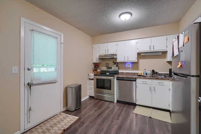 7581-7583 Pickett Ln Unit 83, Columbus, OH 43235 - kitchen with stainless steel appliances, under cabinet range hood, a sink, white cabinetry, and dark wood-style floors