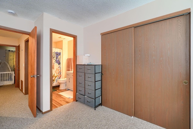 7581-7583 Pickett Ln Unit 83, Columbus, OH 43235 - carpeted bedroom with a closet and a textured ceiling