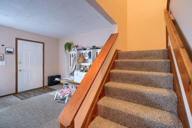 7581-7583 Pickett Ln Unit 83, Columbus, OH 43235 - stairway featuring carpet and a textured ceiling