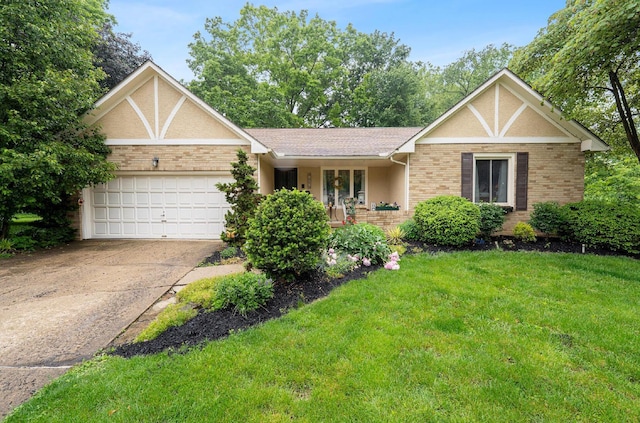 1027 Peggys Cv, Reynoldsburg, OH 43068 - english style home with a garage, concrete driveway, a front yard, and brick siding