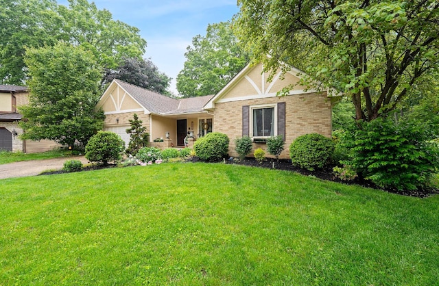 1027 Peggys Cv, Reynoldsburg, OH 43068 - tudor house with brick siding, an attached garage, a front yard, and asphalt driveway