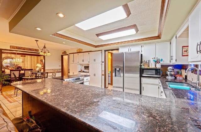 1027 Peggys Cv, Reynoldsburg, OH 43068 - kitchen featuring stainless steel appliances, a sink, a raised ceiling, white cabinets, and recessed lighting