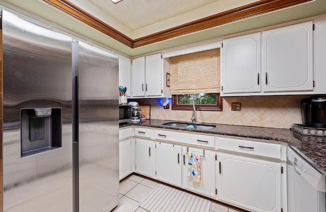 1027 Peggys Cv, Reynoldsburg, OH 43068 - kitchen with appliances with stainless steel finishes, a sink, tasteful backsplash, white cabinetry, and a textured ceiling
