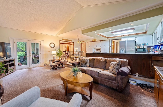 1027 Peggys Cv, Reynoldsburg, OH 43068 - carpeted living area with french doors, lofted ceiling, ornamental molding, and a raised ceiling
